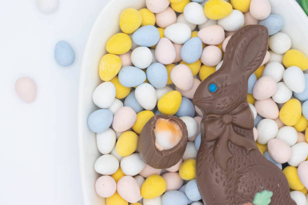 istock Chocolate bunny with cadbury creme egg on top of candy eggs 1391530768