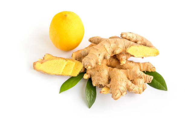 istock On isolated white background fresh ginger roots with leaves and lemon. 1391532502
