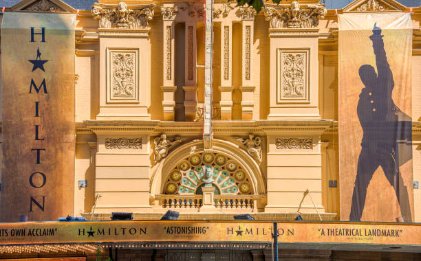 A front view of Her Majesty's Theatre in Melbourne, decorated with the signage of the musical production Hamilton Melbourne, Victoria, Australia, March 12th, 2022: A front view of Her Majesty's Theatre in Melbourne, decorated with the signage of the musical production Hamilton hamilton on stock pictures, royalty-free photos & images