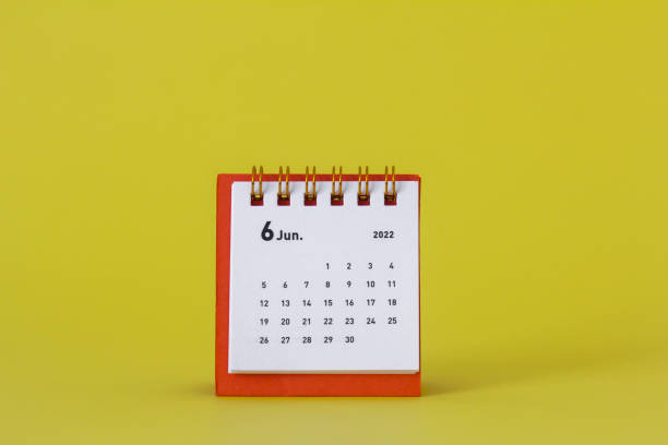 istock Desktop calendar for June 2022 on a yellow background. 1391536974