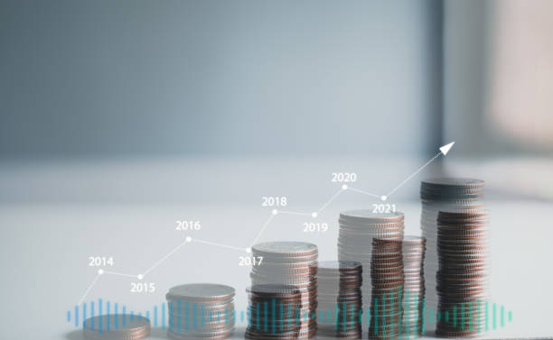istock stacking coins with a graph of profit. Business successful growth. 1391536977