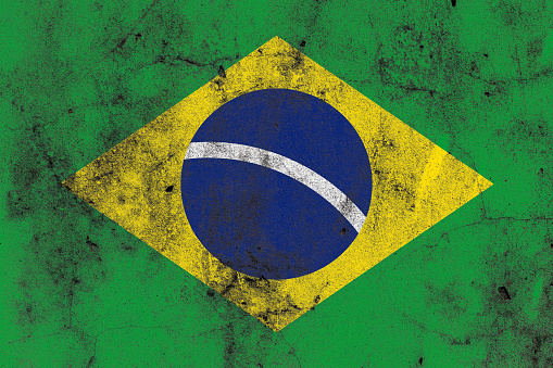Painted brazil flag on a distressed old concrete wall surface