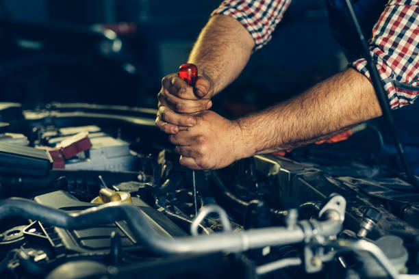 istock Car mechanic checking oil level in a mechanical workshop 1391541708