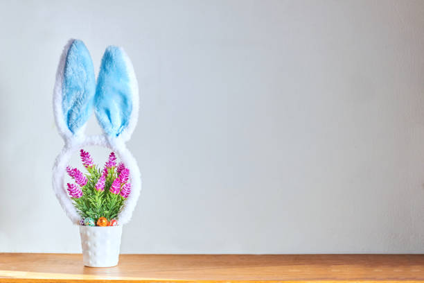 istock Rabbit ears headband on a decorative flower pot. Easter concept with copy space 1391541889