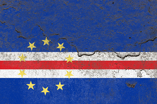 Distressed old cabo verde flag on a concrete wall surface