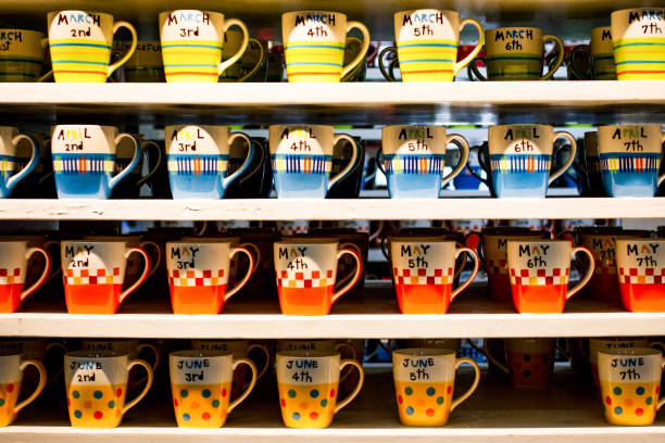 colorful coffe cup by month on shelf background