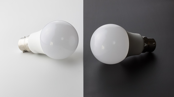 Two led bulbs, next to each other. Light bulbs on grey and white background - with copy space