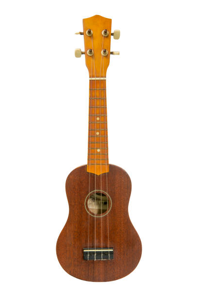 The old brown ukulele on the white background The old brown ukulele on the white background ukulele stock pictures, royalty-free photos & images