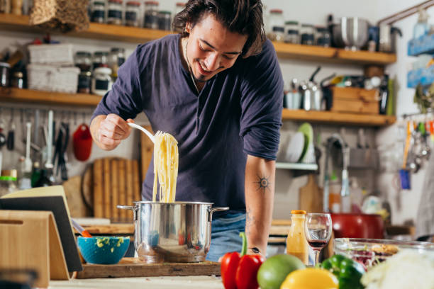 istock man preparing food at home 1391549570