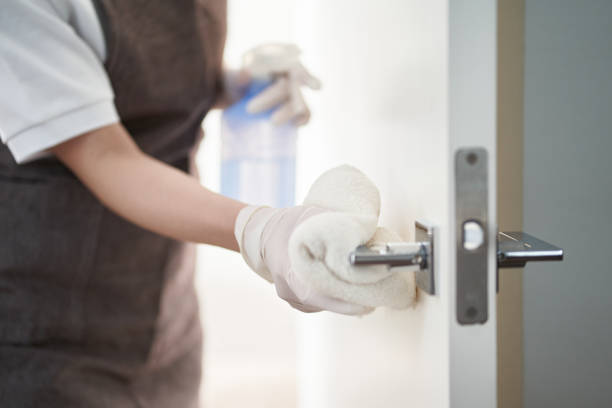 istock Asian woman sterilizing door handles with alcohol 1391551206