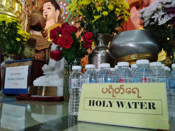 holy water at burmese buddhist temple, penang, malaysia. - holy water spirituality water bottle imagens e fotografias de stock
