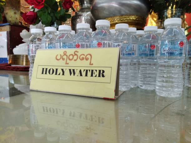 holy water at burmese buddhist temple, penang, malaysia. - holy water spirituality water bottle imagens e fotografias de stock