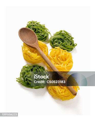 istock Uncooked dry pasta and wood spoon 1391556223