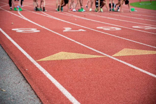 istock Runners on the starting blocks on an athletic racing track 1391557521