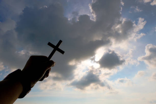 istock Hand holding wooden cross 1391557575