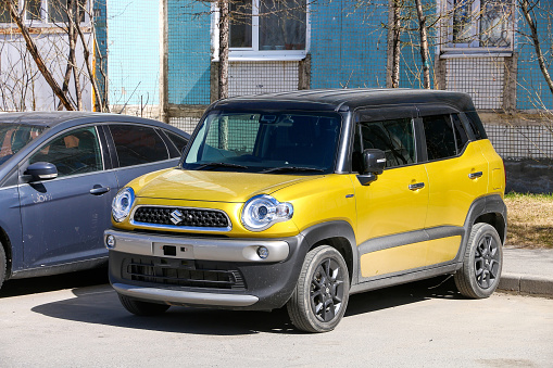 Novyy Urengoy, Russia -May 29, 2021: Yellow compact van Suzuki Xbee in a city street.