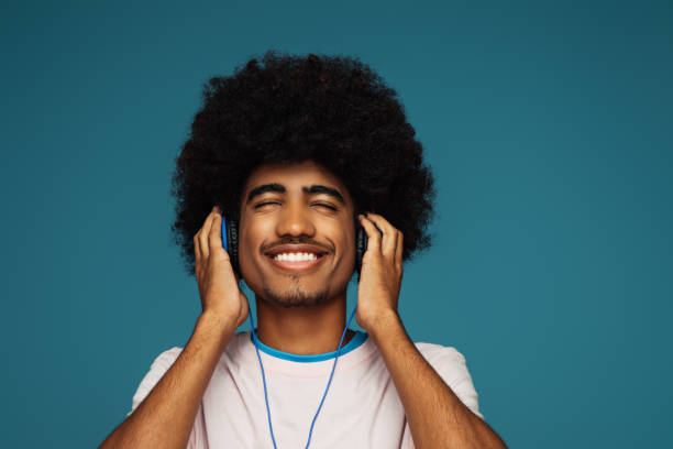 istock African american man with african hairstyle using phone 1391558542