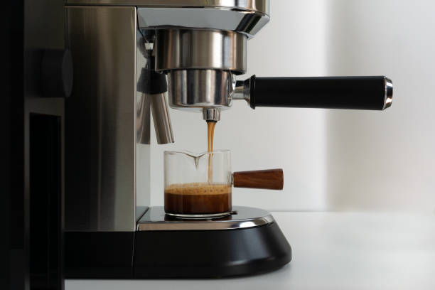 istock The espresso coffee flowing from coffee machine into a small glass 1391559546