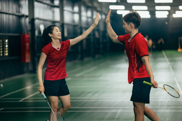 istock Taiwanese badminton players warm up exercise practicing in badminton court endurance training 1391562435