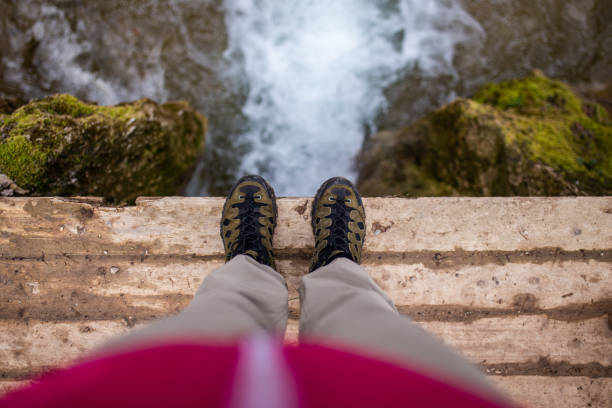 istock Personal perspective of unrecognizable woman standing above the waterfall 1391564802