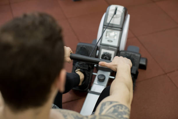 istock Man running rowing exercise in the gym. 1391565803