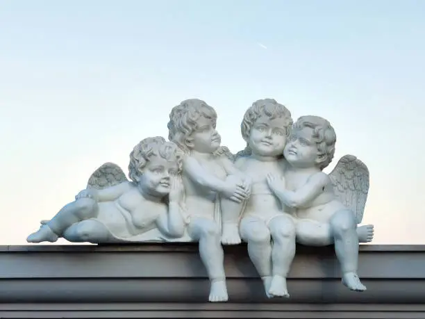 sculptures of child angels sitting on the roof.