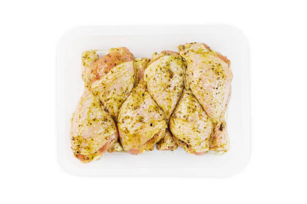 istock Marinated chicken leg in red sauce on isolated white background.Top view.Copy space.Semifinished. Fast cooking.Raw marinated chicken meat. 1391566746