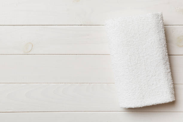 istock Top view of white towels with copy space on colored background 1391566787