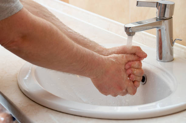 istock Closeup image of man washing hands in bathroom 1391568295
