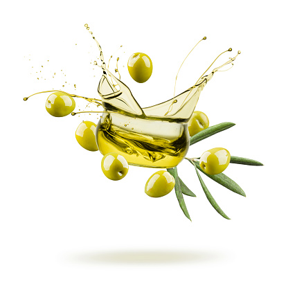 olive oil bowl jumping and splashing with green olives on white background