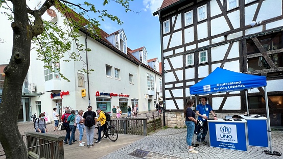 Tübingen, Germany - April, 14 - 2022: People collecting money for the UNHCR.