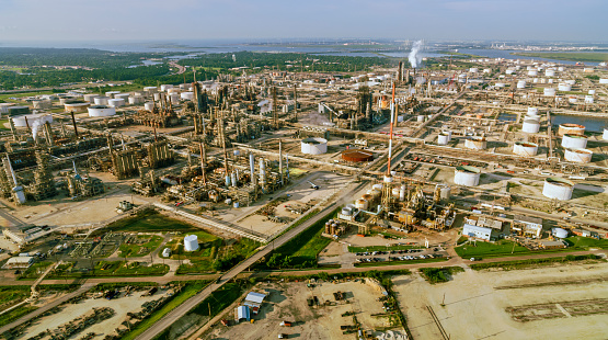 Aerial view of plumes of smoke rising out of the oil refinery towers in Houston, Texas, USA.
