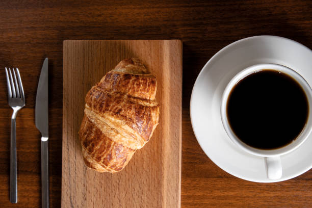 istock Croissant with a cup of full coffee,directly above 1391573458
