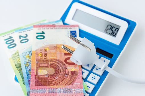 Power cord on calculator and euro banknotes