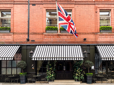 Covent Garden london facade of restaurant Monmouth street british flag tables outdoor red brick