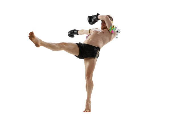 istock Dynamic portrait of professional thai boxer practicing isolated on white studio background. Sport, muay thai, competition, fight club concept 1391577025