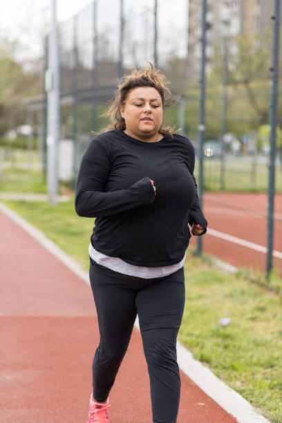 istock Overweight Hispanic woman running outside 1391578026