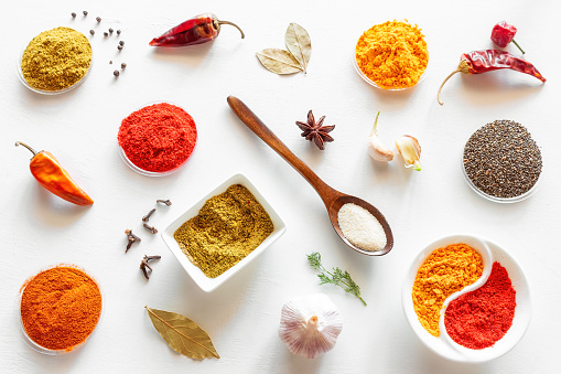 spices, seasonings, garlic, pepper and other herbs on a white background