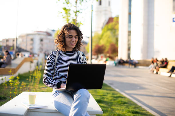 istock Young student girl smiling happy using laptop at the university 1391579294