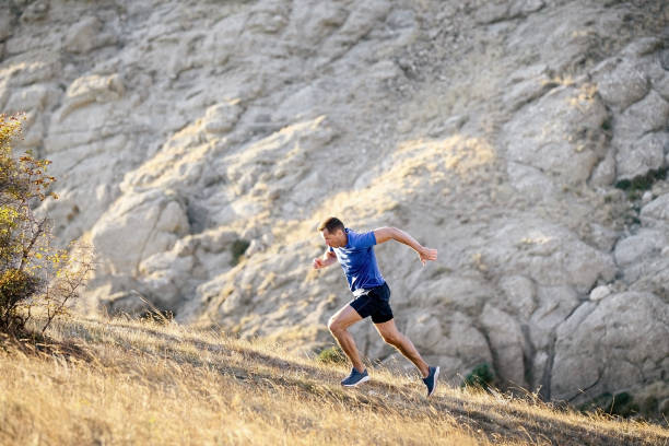 istock athlete runner running uphill on cliff background 1391579330