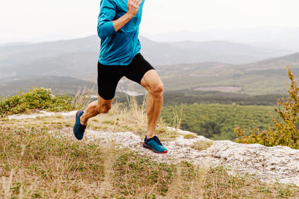 istock male runner run mountain trail in blue windbreaker 1391579340