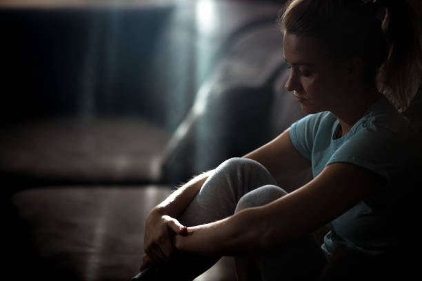 Pensive woman feeling sad and lonely while being in quarantine at home. Copy space.