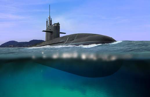 Submarino naval flotando y medio sumergido en aguas poco profundas photo