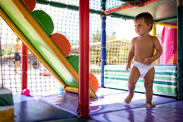 istock Boy in diaper with ball playing in playroom on weekend 1391582014