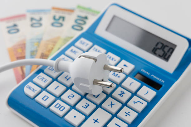 istock Power cord on calculator and euro banknotes 1391582254