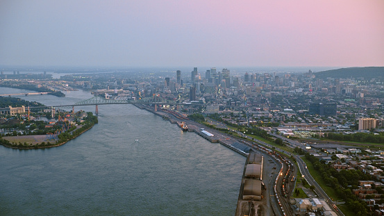 Aerial view of skyline of Downtown Montreal and Saint Lawrence River during sunset in Quebec, Canada.