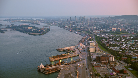 Aerial view of skyline of downtown Montreal and Saint Lawrence River during sunset in Quebec, Canada.