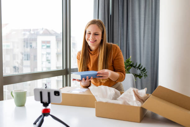istock Young woman shooting a video at home 1391584197