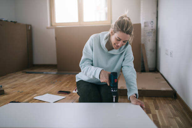 istock Woman assembling furniture at home 1391584453