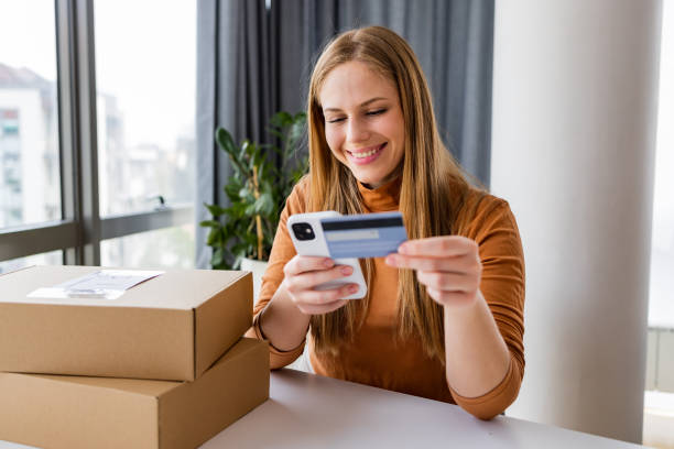 istock Young woman using smart phone to shop online 1391584471